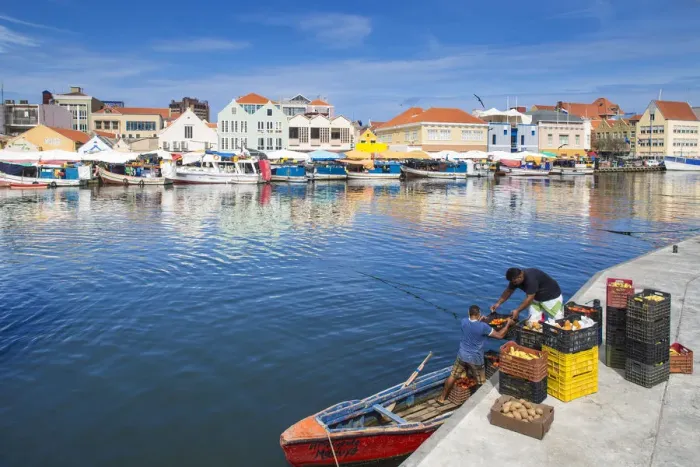 Framed Print : Curacao, Willemstad, Punda, Venezuelan men loading produce for the floating market Framed Print : Curacao, Willemstad, Punda, Venezuelan men loading produce for the floating market