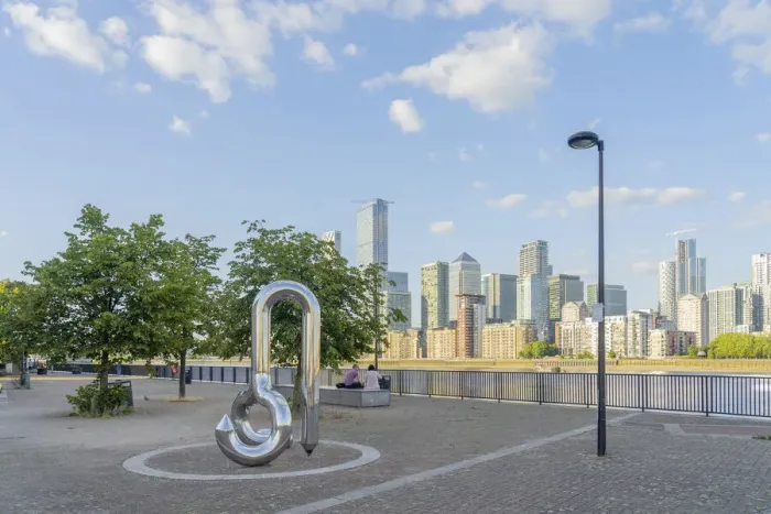 Framed Print : Curlicue sculpture by William Pye and Canary Wharf and the River Thames, London, England Framed Print : Curlicue sculpture by William Pye and Canary Wharf and the River Thames, London, England