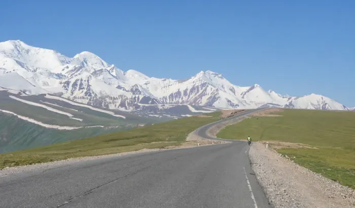 Framed Print : Cyclist along Irkestam pass road with Pamir peaks in the background Framed Print : Cyclist along Irkestam pass road with Pamir peaks in the background