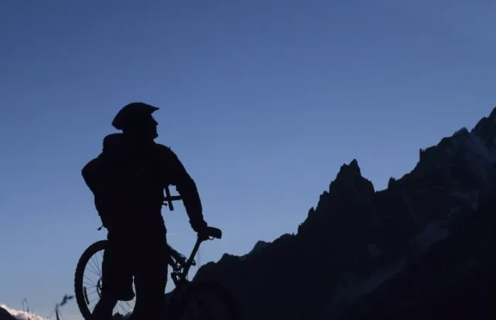 Framed Print : A cyclist on a mountain bike tour of Mont Blanc