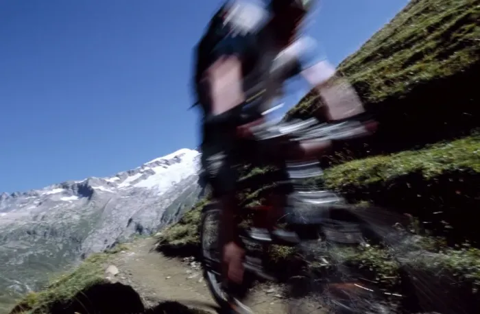 Framed Print : A cyclist mountain biking on Mont Blanc