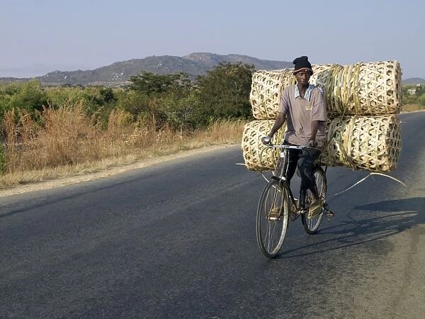 A cyclist taking baskets to market