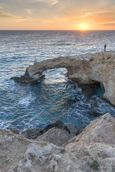 Cyprus, Ayia Napa, Cape Greco, man at sunset standing over the Love Bridge