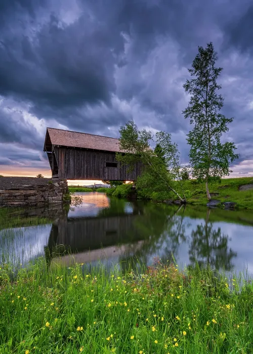 Framed Print : Dark clouds over the A.M. Foster Bridge with Buttercup flowers, Green Mountains, Cabot, Vermont, USA Framed Print : Dark clouds over the A.M. Foster Bridge with Buttercup flowers, Green Mountains, Cabot, Vermont, USA
