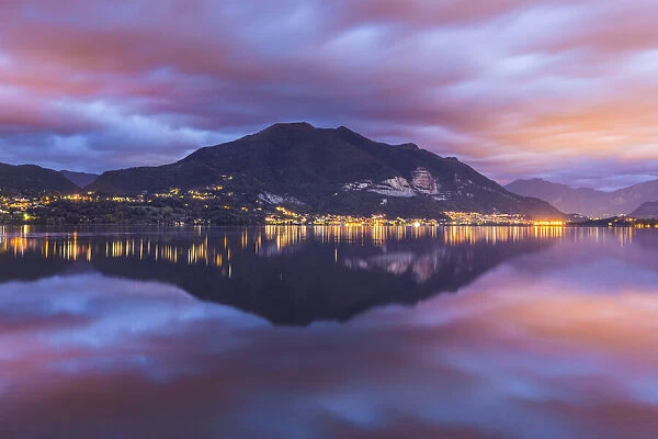 Dawn on Cornizzolo mount reflected on Pusiano lake, Lecco province, Lombardy, Italy