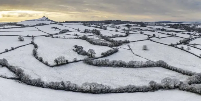 Framed Print : Dawn sky over snow covered countryside near Brentor Church, Devon, England Framed Print : Dawn sky over snow covered countryside near Brentor Church, Devon, England