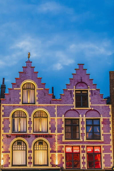 Details of the typical colored houses facades in Markt square in Bruges by night, Belgium