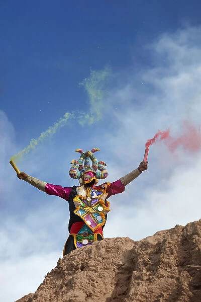 A devil mask of the Uquia's Carnival with bengala's during the 'Descents of the Devil's', Jujuy, Argentina. Hundreds of devils descend from the 'Cerro Blanco' hill to celebrate the start of Carnival