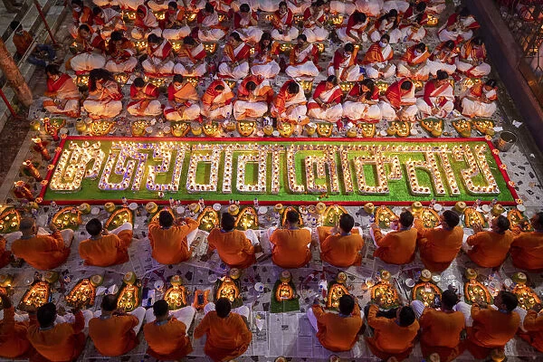 Devotees attend prayer with burning incense and light oil lamps before break fasting
