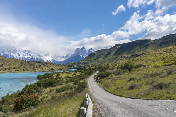 Dirt road and Lake Pehoa and Paine Horns in the background, in summer