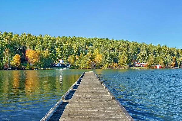 Dock and cottages and Autumn on Crow Lake (also known as Kakagi Lake). Near Sioux Narrows, Ontario, Canada