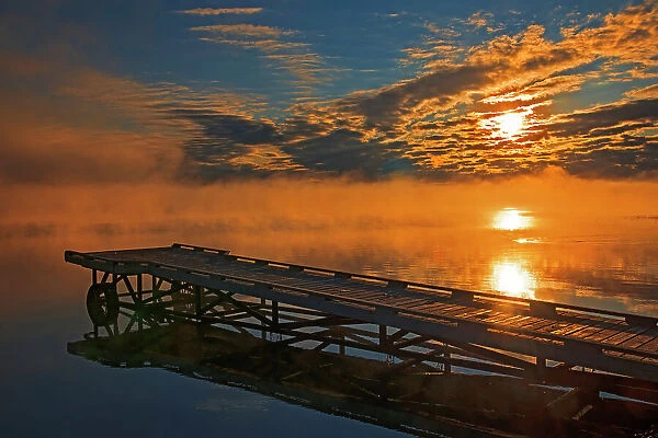 Dock in fog at sunrise on Sturgeon Lake Williamson Provincial Park Alberta, Canada