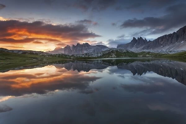 Dolomites, Italy. Clouds and colors at dawn are reflected at Laghi dei Piani, not