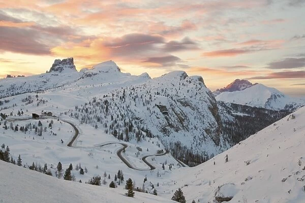 Dolomites, Veneto, Italy. Winter sunrise towards Falzarego with Mount Averau in the