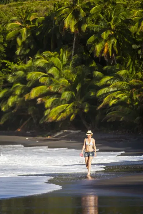 Framed Print : Dominica, Hampstead. A woman walks along No 1 Beach. (MR) Framed Print : Dominica, Hampstead. A woman walks along No 1 Beach. (MR)