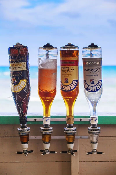 Dominican Republic, Samana Peninsula, Las Terrenas, Bottles of Brugal Rum in beach