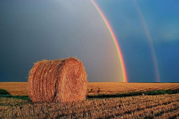 Double rainbow and bale after prairie storm Near Cypress River, Manitoba, Canada