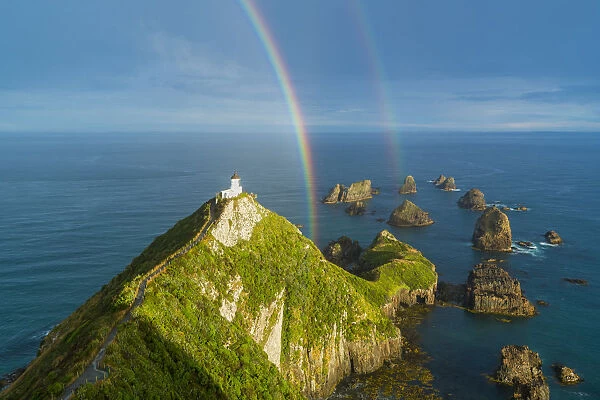 Double rainbow over Nugget Point lighthouse after the storm