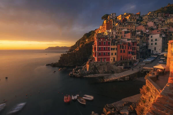 A dramatic autumnal sunset in Riomaggiore, Cinque Terre, where the last light of the day hit the walls of the small fishermens village