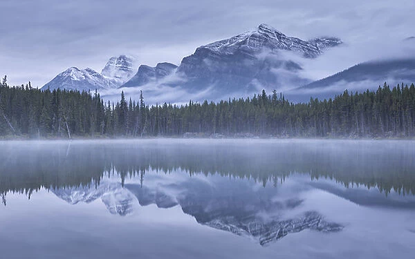 Dramatic Canadian Rockies mountain vista reflected in Herbert Lake, Banff National Park
