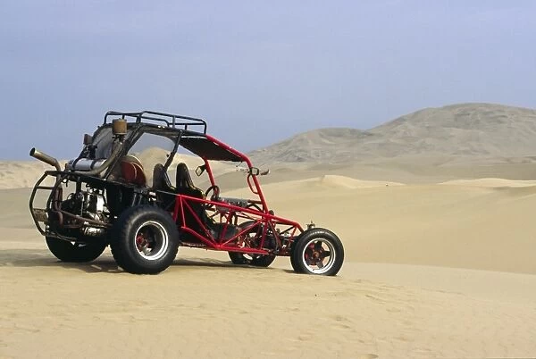 A dune buggy sits in the desert expense of Peru s