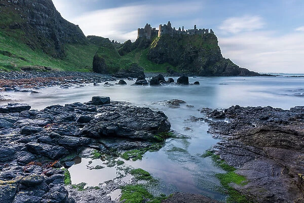 Dunluce Castle perched dramatically on the clifftops of the Causeway Coast, County Antrim, Northern Ireland. Autumn (November) 2022