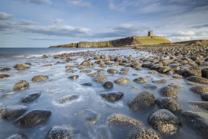 Framed Print : Dunstanburgh Castle from the rocky shores of Embleton Bay, Northumberland, England Framed Print : Dunstanburgh Castle from the rocky shores of Embleton Bay, Northumberland, England
