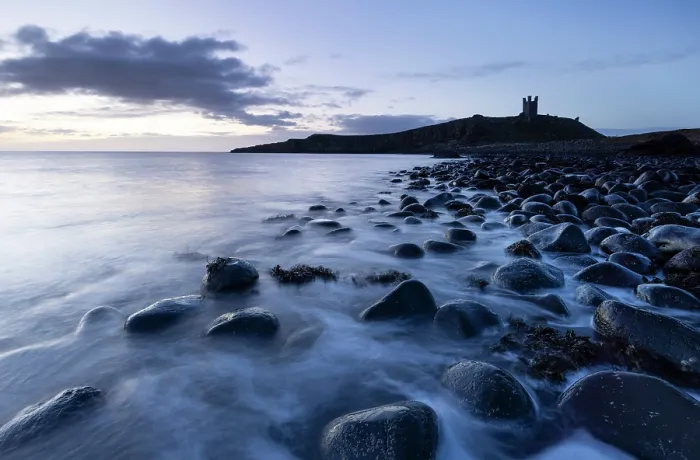 Framed Print : Dunstanburgh Castle ruins and beach of basalt boulders near Embleton, Northumberland, England Framed Print : Dunstanburgh Castle ruins and beach of basalt boulders near Embleton, Northumberland, England