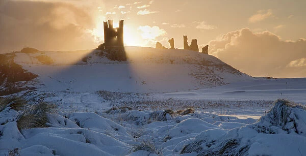 Dunstanburgh Castle at sunrise, Northumberland, England