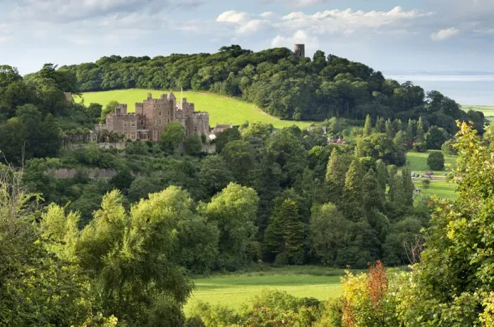 Framed Print : Dunster Castle and Conygar Tower in Exmoor National Park, Somerset, England. Summer Framed Print : Dunster Castle and Conygar Tower in Exmoor National Park, Somerset, England. Summer