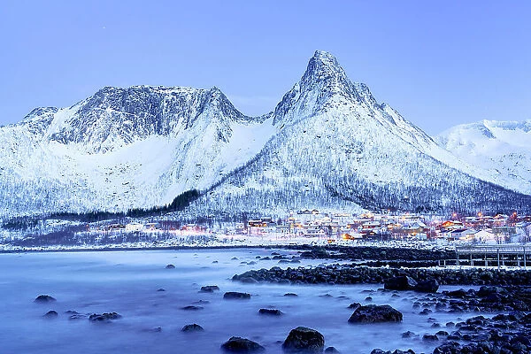 Dusk over Mefjordvaer village covered with snow in winter, Senja, Troms county, Norway
