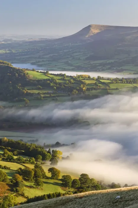 Framed Print : Early morning mist rolls over patchwork countryside in the Brecon Beacons National Park