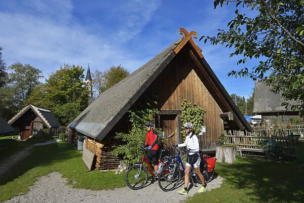 Electric cyclists push through Bayuwarendorf, Mattsee, Salzburg Lake District, Salzburg