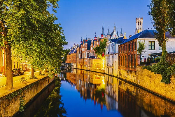 Elevated view of Bruges old town reflecting in the water canal at sunset by night