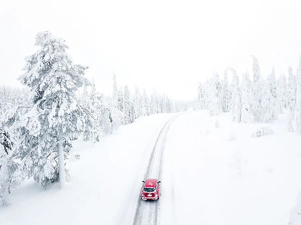 Elevated view of car along the snowy road in the icy forest, Pallas-Yllastunturi