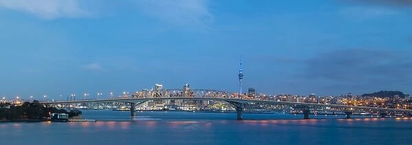 Elevated View Towards the Harbour Bridge and Central Business District illuminated at dusk, Auckland, North Island
