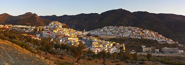 Elevated view over the historic hilltop town of Moulay Idriss illuminated at sunset