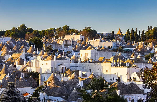 Elevated view of monumental trulli area at sunrise. Unesco World Heritage Site