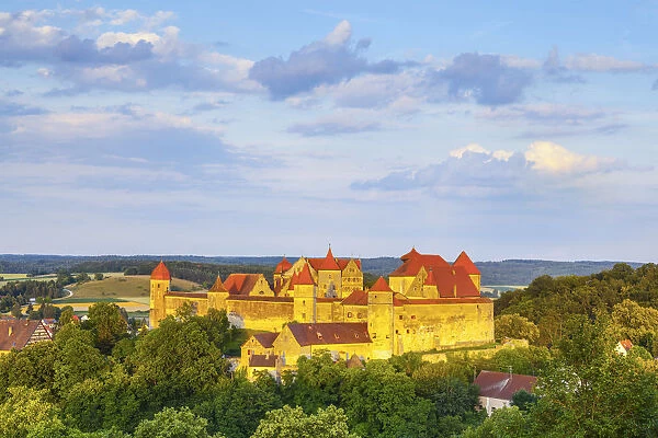 Elevated view towards the picture-perfect Harburg Castle illuminated at sunset, Harburg