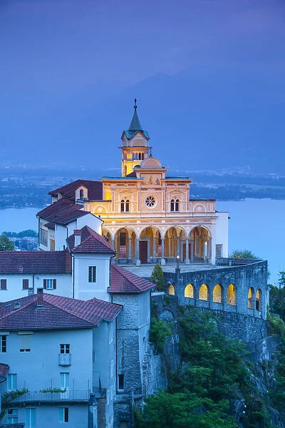 Elevated view over the picturesque Sanctuary of Madonna del Sasso illuminated at dusk