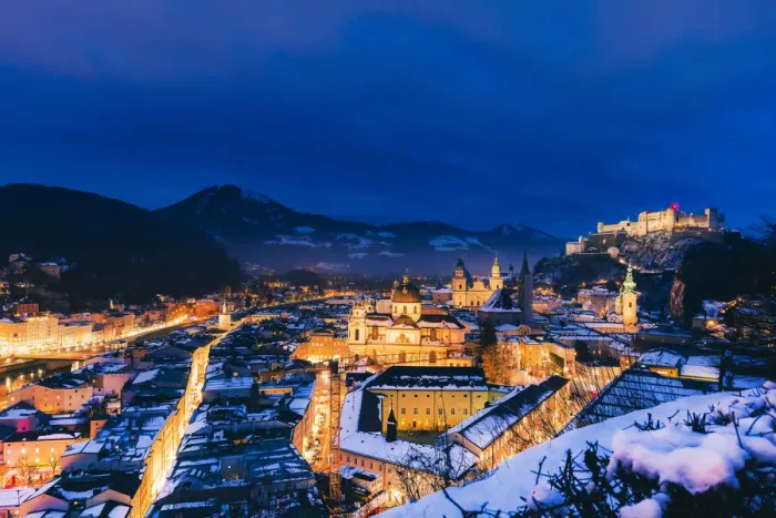 Framed Print : Elevated view of Salzburg city by night on a winter evening with the roofs covered Framed Print : Elevated view of Salzburg city by night on a winter evening with the roofs covered