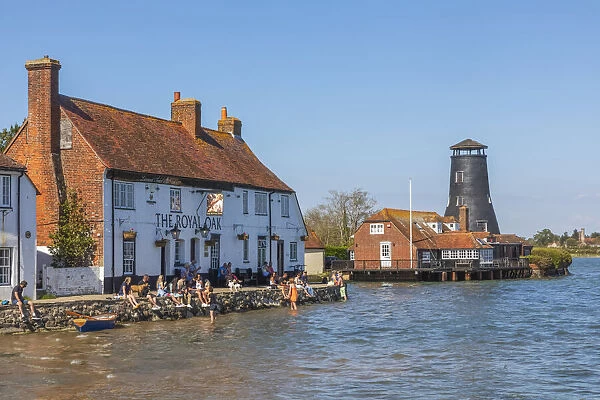 England, Hampshire, Langstone, Chichester Harbour, View of The Royal Oak Pub and Customers at High Tide