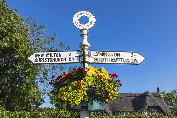 England, Hampshire, The New Forest, Milford-on-sea, Signpost and Flower Basket