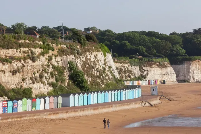 Framed Print : England, Kent, Broadstairs, Stone Bay, Long Row of Colourful Beach Huts and Dog Walker Framed Print : England, Kent, Broadstairs, Stone Bay, Long Row of Colourful Beach Huts and Dog Walker