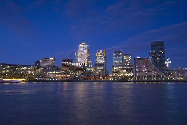 England, London, Docklands, Canary Wharf viewed across River Thames at twilight