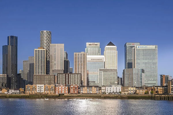England, London, Docklands, River Thames and Warm Early Morning Light on The Modern Canary Wharf Skyline