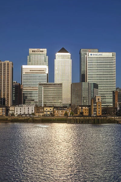 England, London, Docklands, River Thames and Warm Early Morning Light on The Modern Canary Wharf Skyline