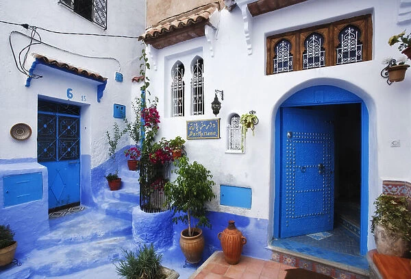 Entrance to Riad with blue painted steps and doorway, Chefchaouen, Morocco