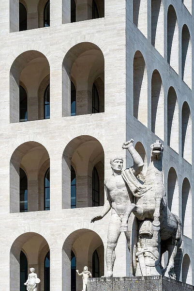 Equestrian sculpture with Palace of Italian Civilization (Palazzo della Civilta Italiana) behind, EUR district, Rome, Lazio, Italy