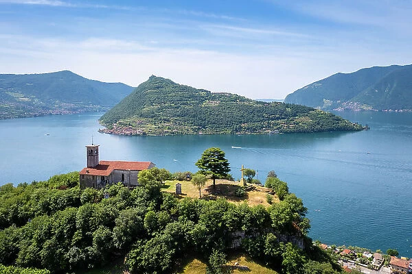 Eremo di San Pietro church on a hill dominating Iseo lake, in front of Montisola. Marone, Brescia province, Lombardy, Italy